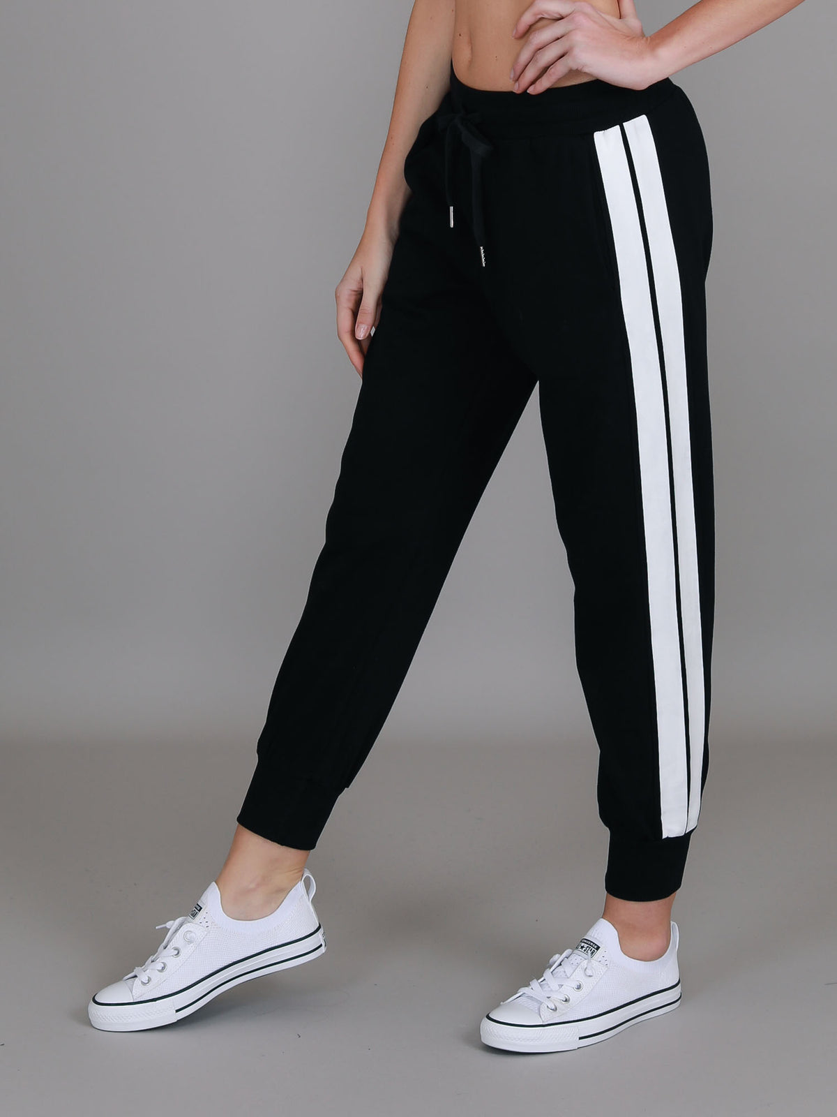 black track pants with white stripe